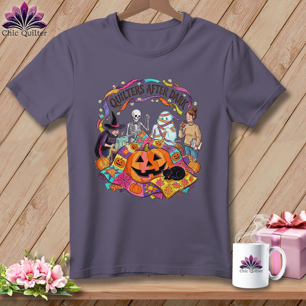 T-shirt graphic of Halloween characters sewing and reading, with text "Quilters After Dark".