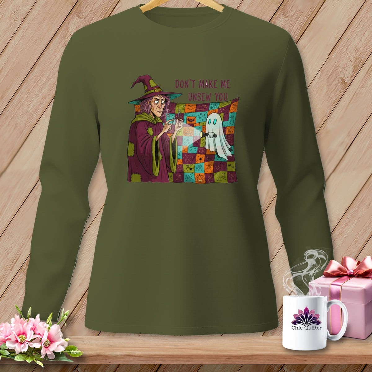 Green long-sleeve shirt with Halloween graphic of a witch and ghost with text.