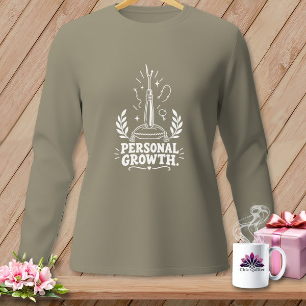 Long-sleeved taupe shirt with "PERSONAL GROWTH" and sewing needle graphic.