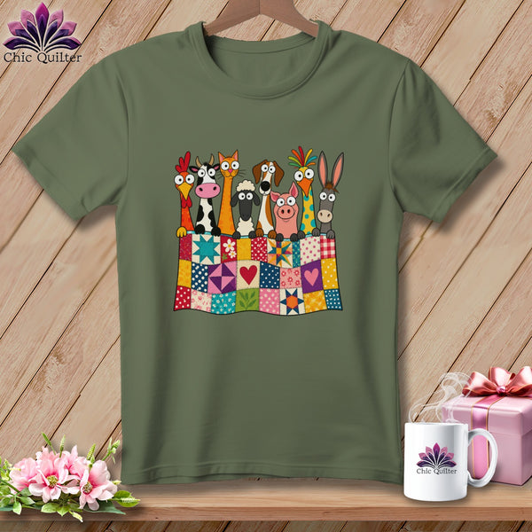 Olive green t-shirt featuring cartoon farm animals peeking over a colorful patchwork quilt.