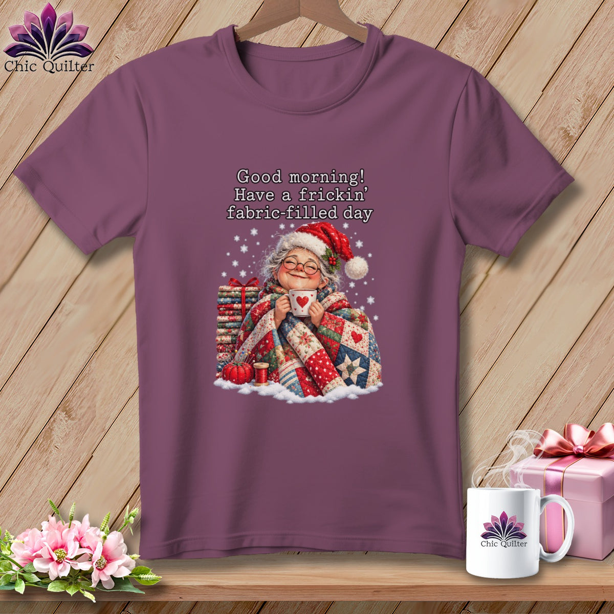 Plum short-sleeve t-shirt with a graphic of an older woman in a Santa hat holding a mug.