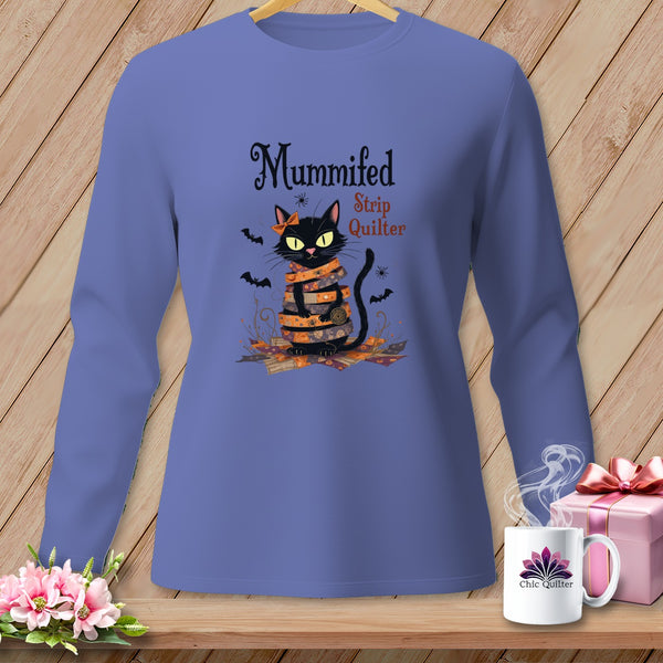 Black cat wrapped in fabric strips with text "Mummified Strip Quilter."
