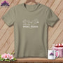 Taupe t-shirt with sewing machine, mountains, and "WHERE I WANDER." text graphic.