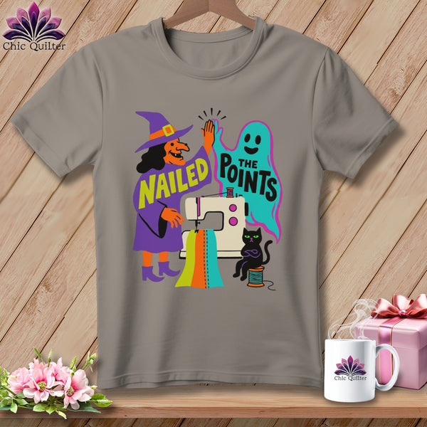 Witch and ghost high-five over sewing machine with text "Nailed The Points."