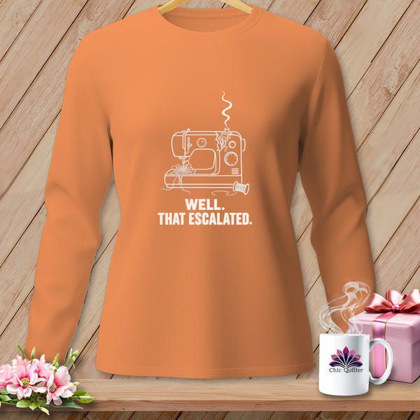 Orange long-sleeve shirt with white line drawing of sewing machine and text "WELL. THAT ESCALATED."