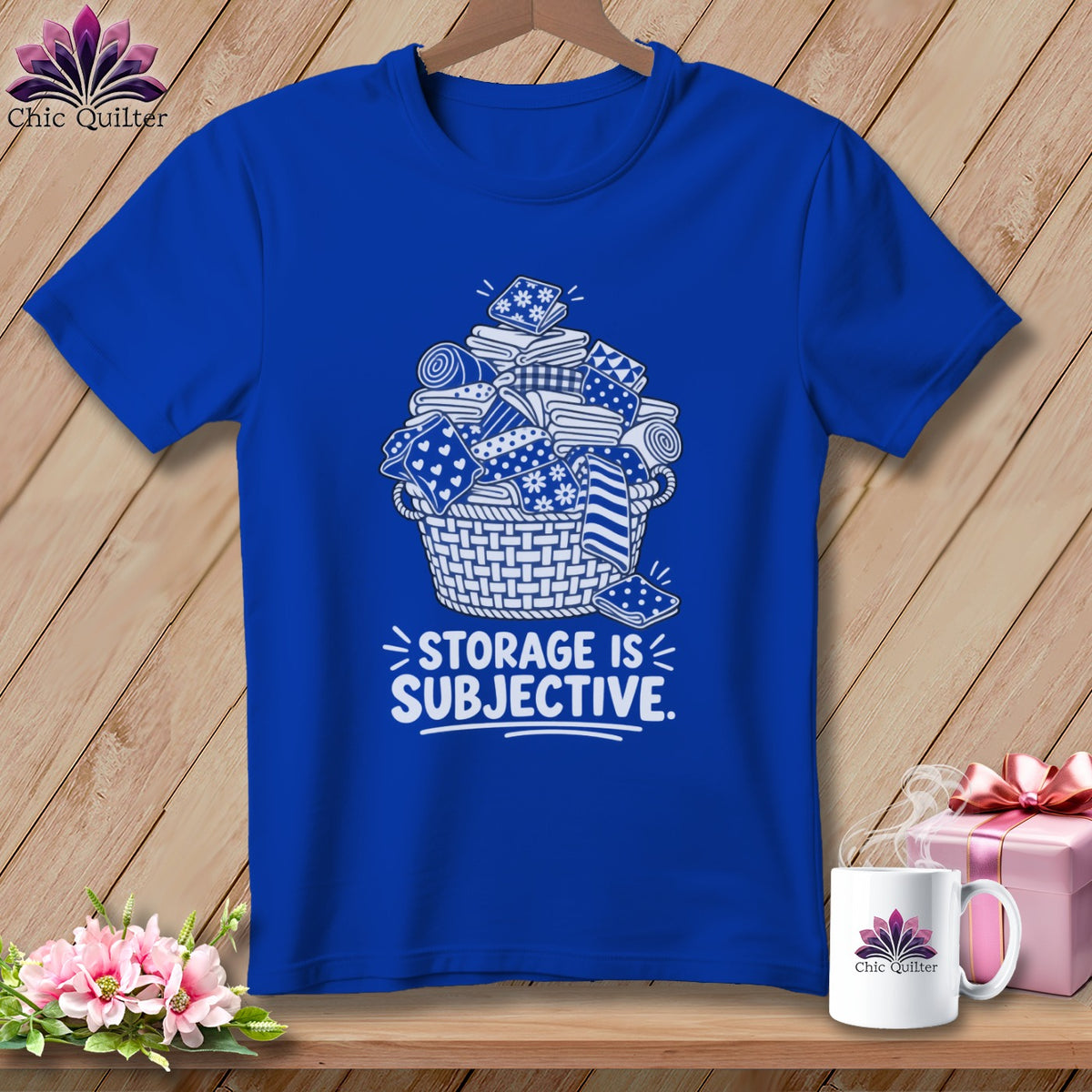 Royal blue t-shirt with a white graphic of fabric in a basket and "Storage is Subjective" text.