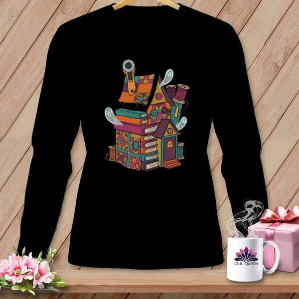Quilting house illustration with books, thread, and ghosts on a black long-sleeve shirt.
