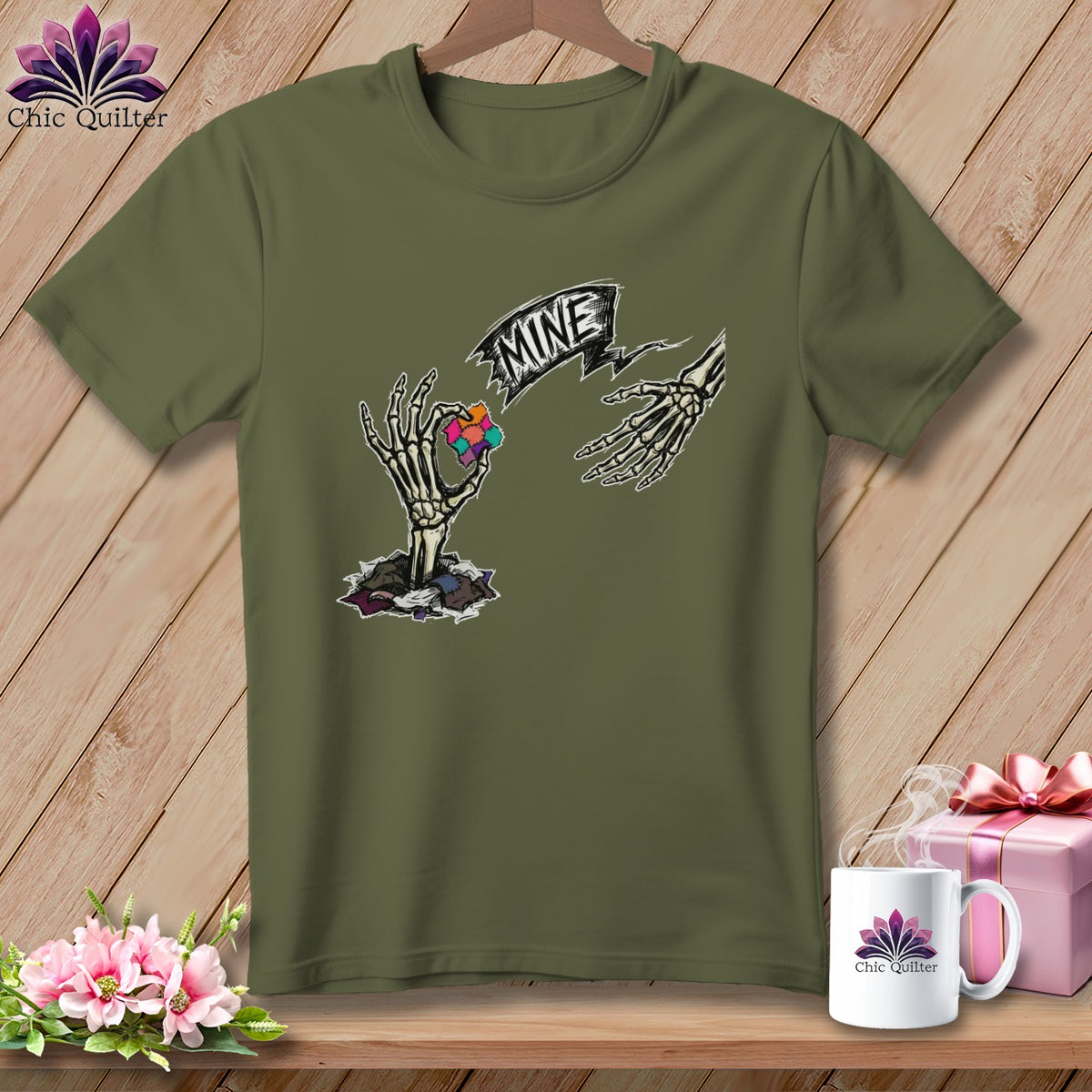 Olive green t-shirt with skeleton hands holding puzzle piece and "MINE" banner.