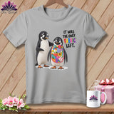 Two penguins, one wearing a patchwork bib, with text 