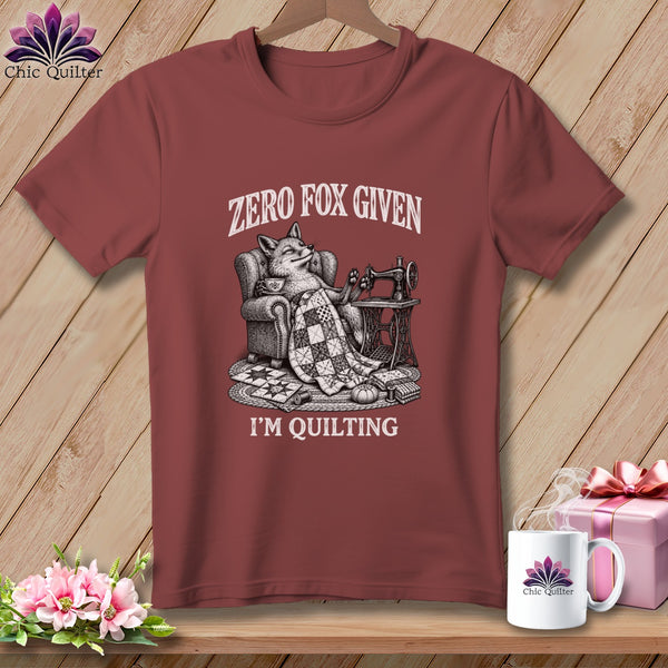 T-shirt with a fox sitting in a chair with a sewing machine and the text "Zero Fox Given I'm Quilting".