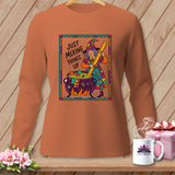 Orange long-sleeve shirt with a witch mixing a cauldron, text says 