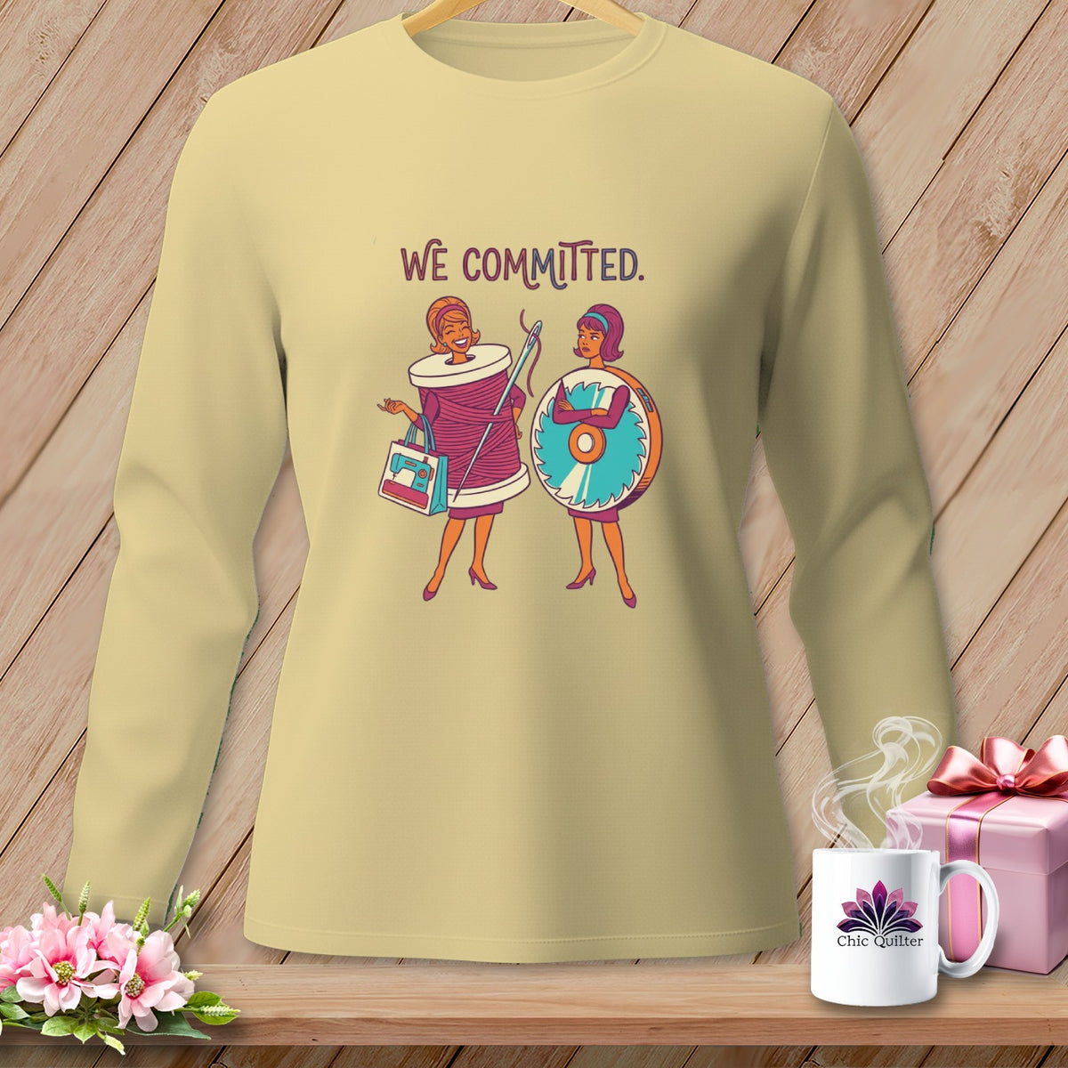 Light yellow long-sleeved shirt with "WE COMMITTED." text and two cartoon women.