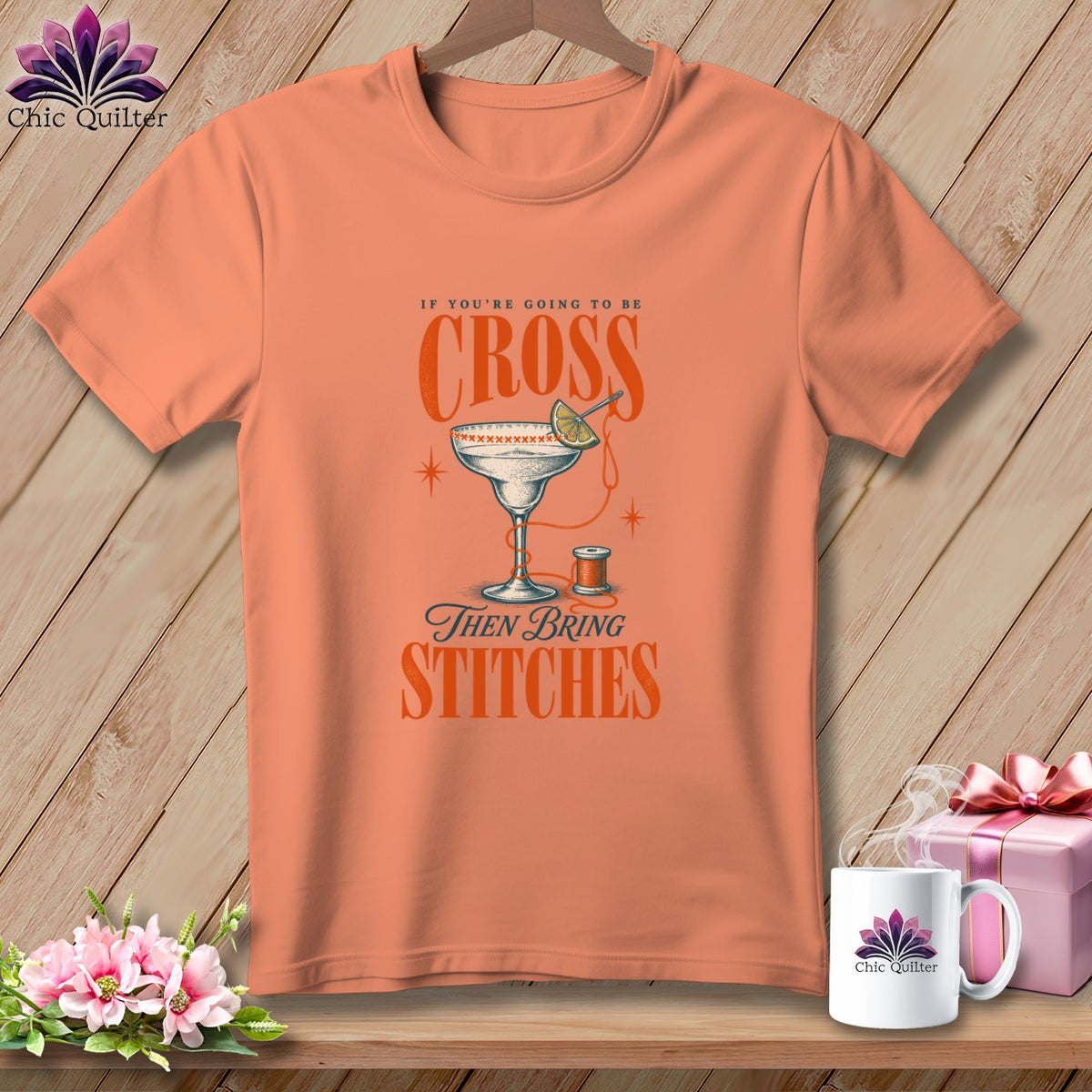 Orange t-shirt with "If you're going to be cross then bring stitches" graphic.
