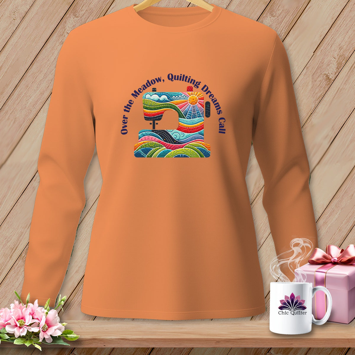Orange long-sleeve shirt with a colorful sewing machine graphic and text.