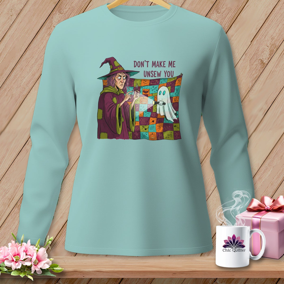 Witch holding a flashlight on a quilt with text "Don't Make Me Unsew You".