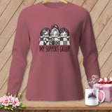 Long-sleeved shirt with graphic of three women peeking over a quilt and text 