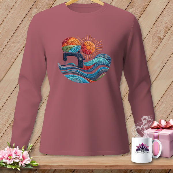 Long-sleeve shirt with sewing machine, sun, and fabric waves graphic.