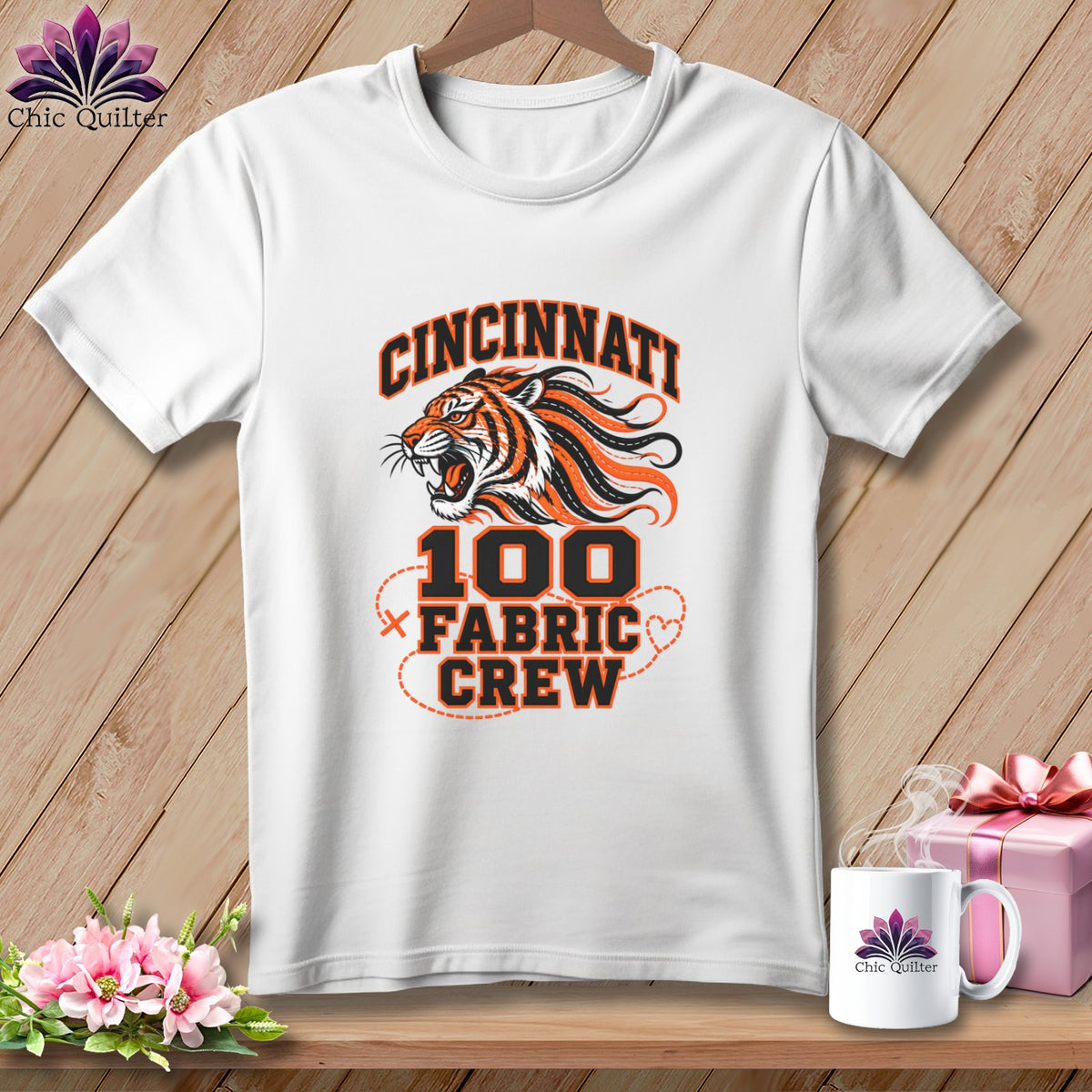 A white t-shirt features a Cincinnati tiger graphic with the text 100 Fabric Crew.