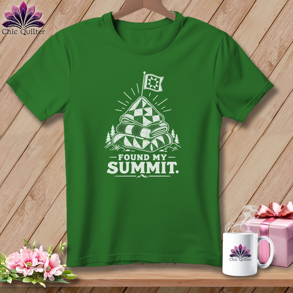Green t-shirt with graphic "Found My Summit" and stacked quilts.