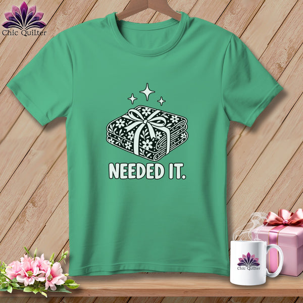 Green t-shirt with folded fabric design and "NEEDED IT." text.
