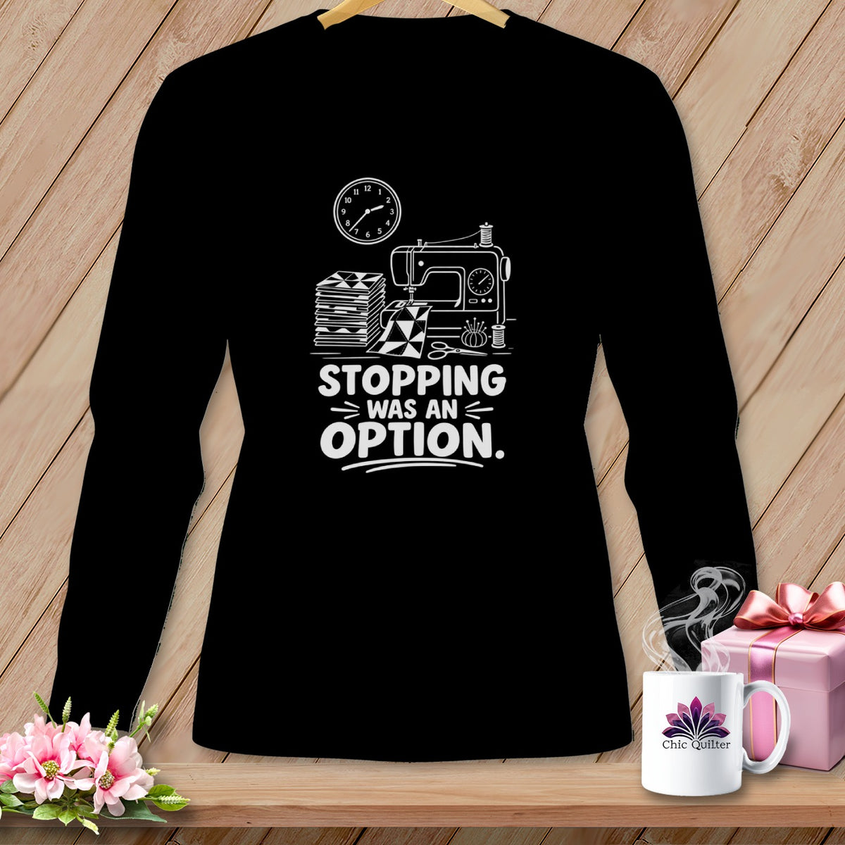 Black long-sleeve shirt with a sewing machine, stacked quilts, and text that reads "STOPPING WAS AN OPTION."