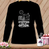 Black long-sleeve shirt with a sewing machine, stacked quilts, and text that reads 