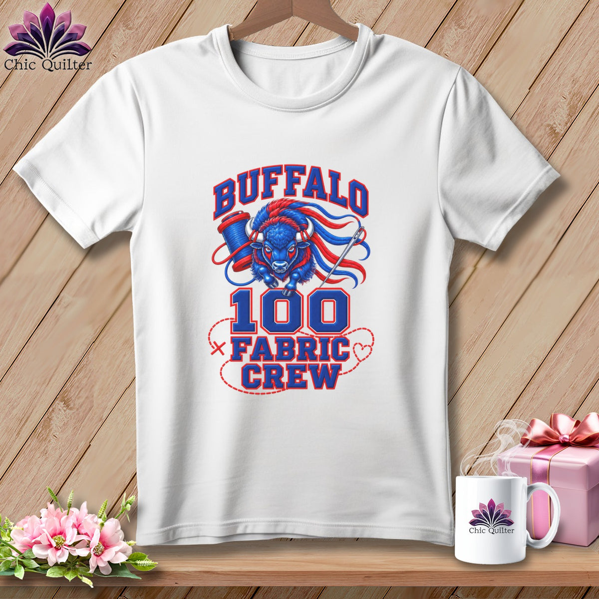 A white t-shirt features a blue and red graphic with a buffalo, sewing spool, needle, and text reading "Buffalo 100 Fabric Crew".