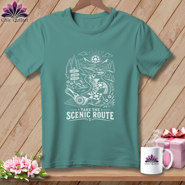 Teal t-shirt with white graphic of a winding road, mountains, trees, and the text "Take the Scenic Route".