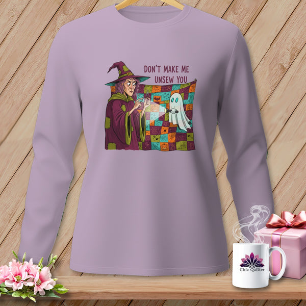 Witch with flashlight shines on ghost and quilt with Halloween patterns. "Don't Make Me Unsew You".