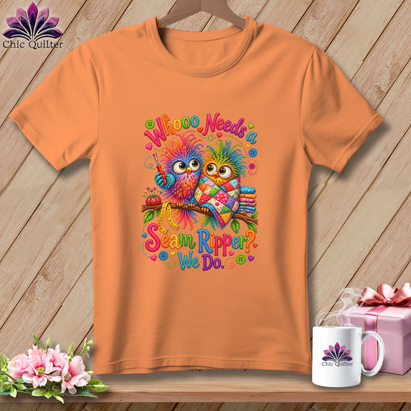 An orange t-shirt displays a graphic of two colorful owls on a branch with sewing-themed text.