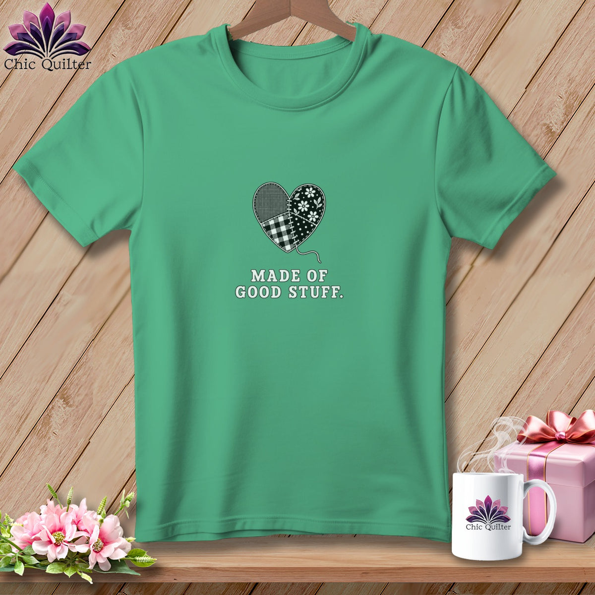 Teal t-shirt with patchwork heart graphic and "Made of Good Stuff" text.