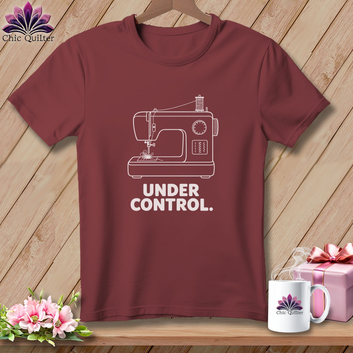 Maroon t-shirt with a white sewing machine graphic and the text "UNDER CONTROL."