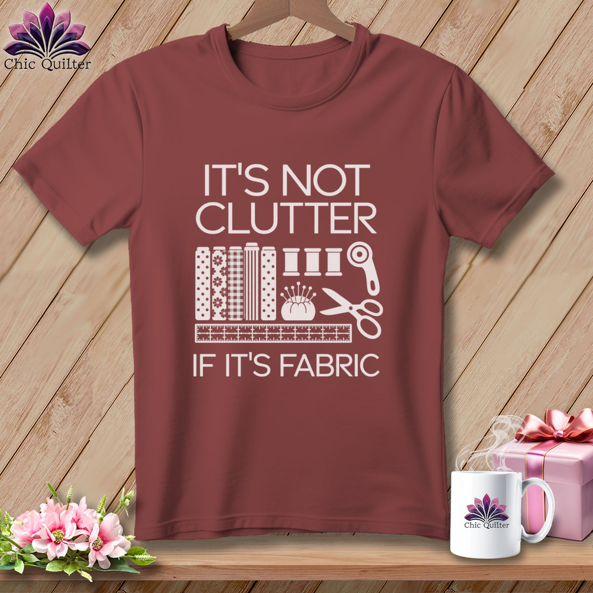 Maroon t-shirt with white text: "IT'S NOT CLUTTER IF IT'S FABRIC" and sewing graphics.