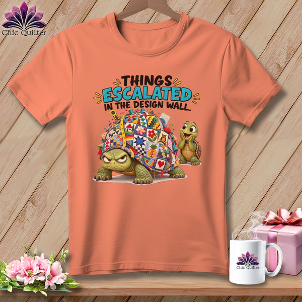 Peach t-shirt with cartoon turtles and "Things Escalated in the Design Wall" text.