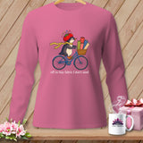 Pink long-sleeve shirt with penguin on bike, carrying fabric, and text 