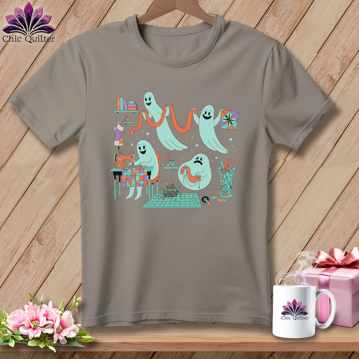 Gray t-shirt with cartoon ghosts sewing and quilting on a wooden background.
