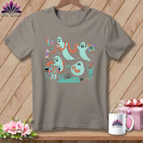 Gray t-shirt with cartoon ghosts sewing and quilting on a wooden background.