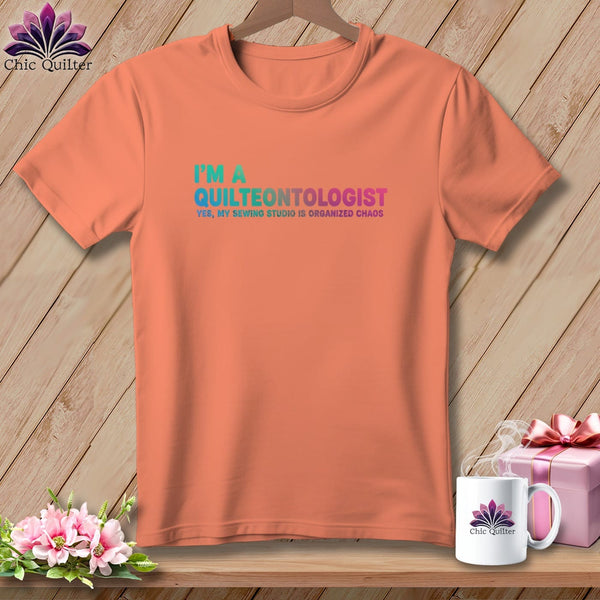 Peach t-shirt with "I'm a Quilteontologist" and "Yes, my sewing studio is organized chaos" text.