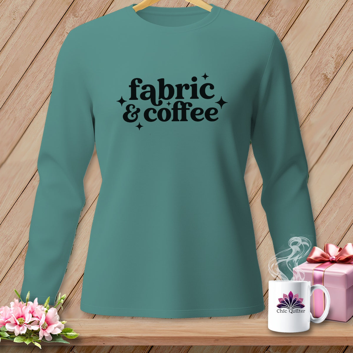 Teal long sleeve shirt with black text "fabric & coffee" and coffee cup logo.