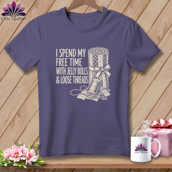 Purple t-shirt with text "I Spend My Free Time With Jelly Rolls & Loose Threads" and quilting motif.