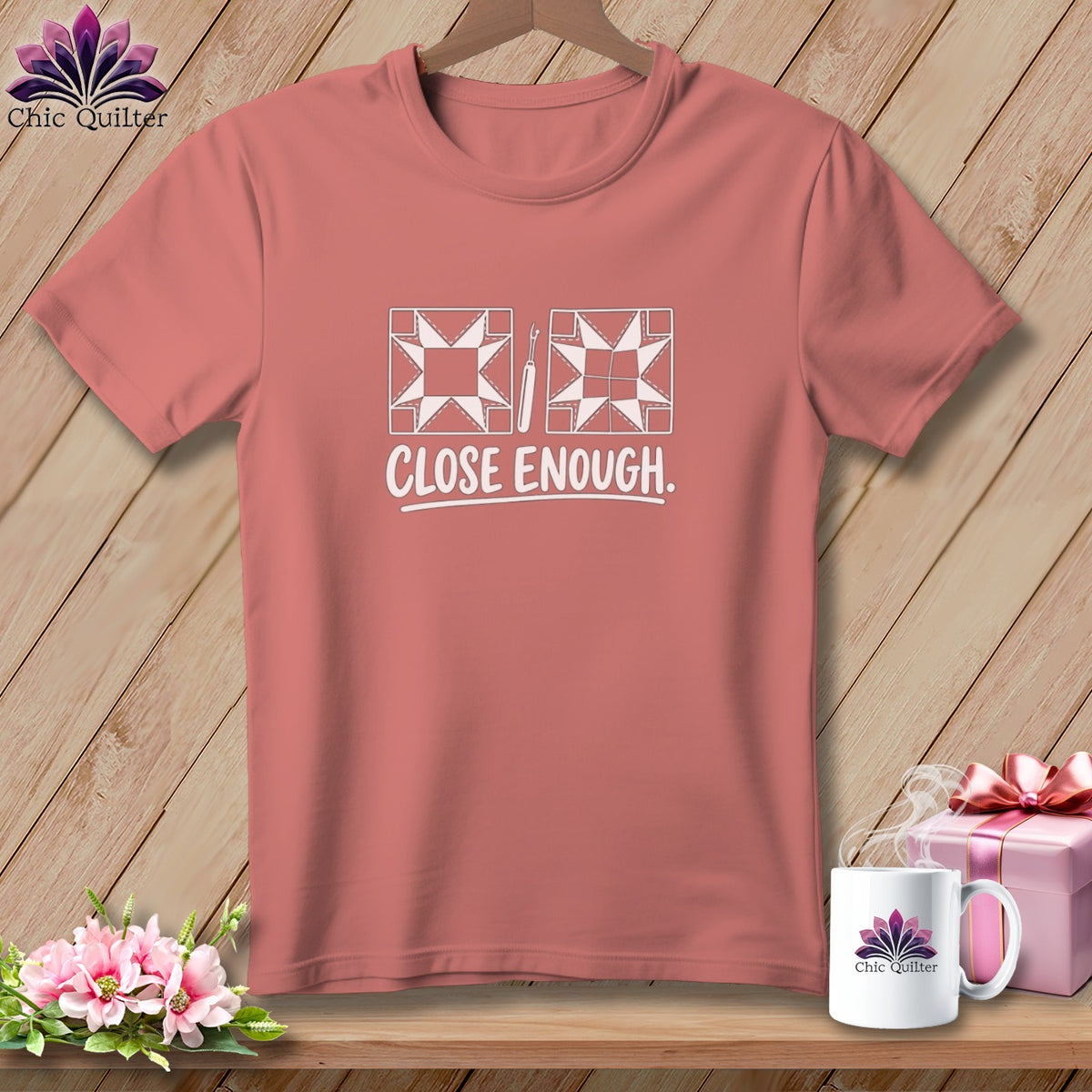 T-shirt with quilting block and seam ripper graphic and "CLOSE ENOUGH." text.