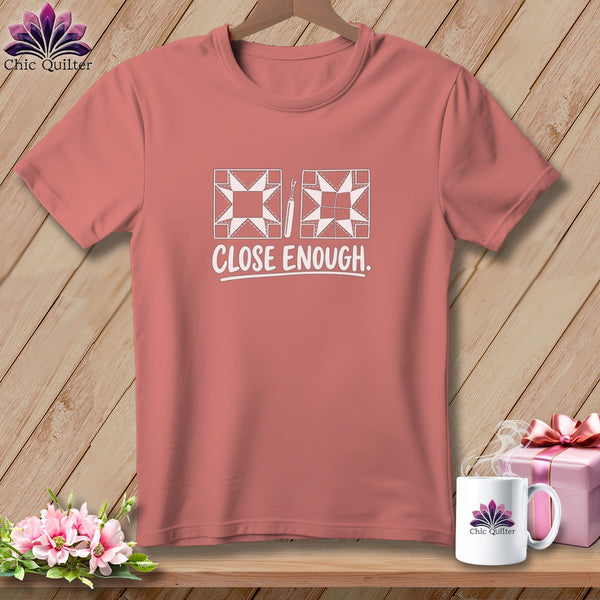 T-shirt with quilting block and seam ripper graphic and "CLOSE ENOUGH." text.