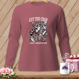 Long sleeve shirt with a raccoon holding a rotary cutter and the text 