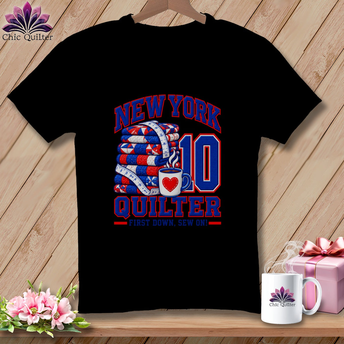 Black t-shirt featuring a New York Quilter graphic with a folded quilt, measuring tape, and mug.