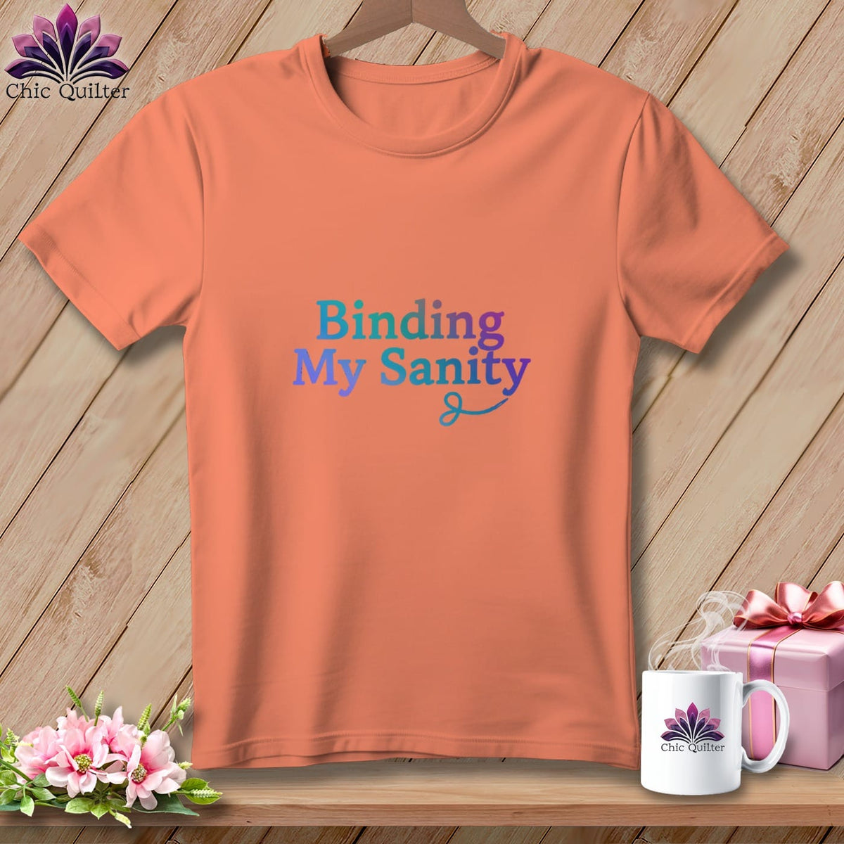 Coral t-shirt with "Binding My Sanity" in gradient text and a sewing needle design.