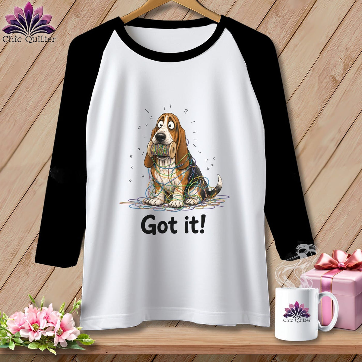 T-shirt with a cartoon basset hound entangled in colorful yarn, saying "Got it!".